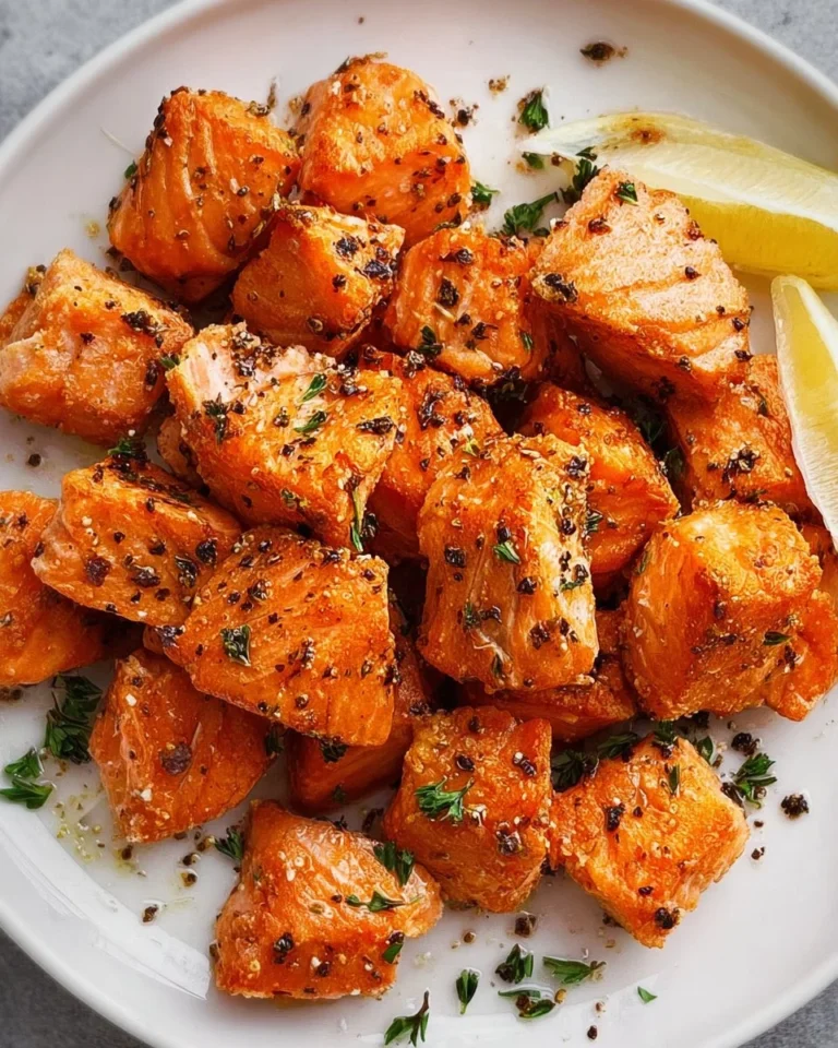 Crispy air fryer salmon bites served on a plate with garnishes.