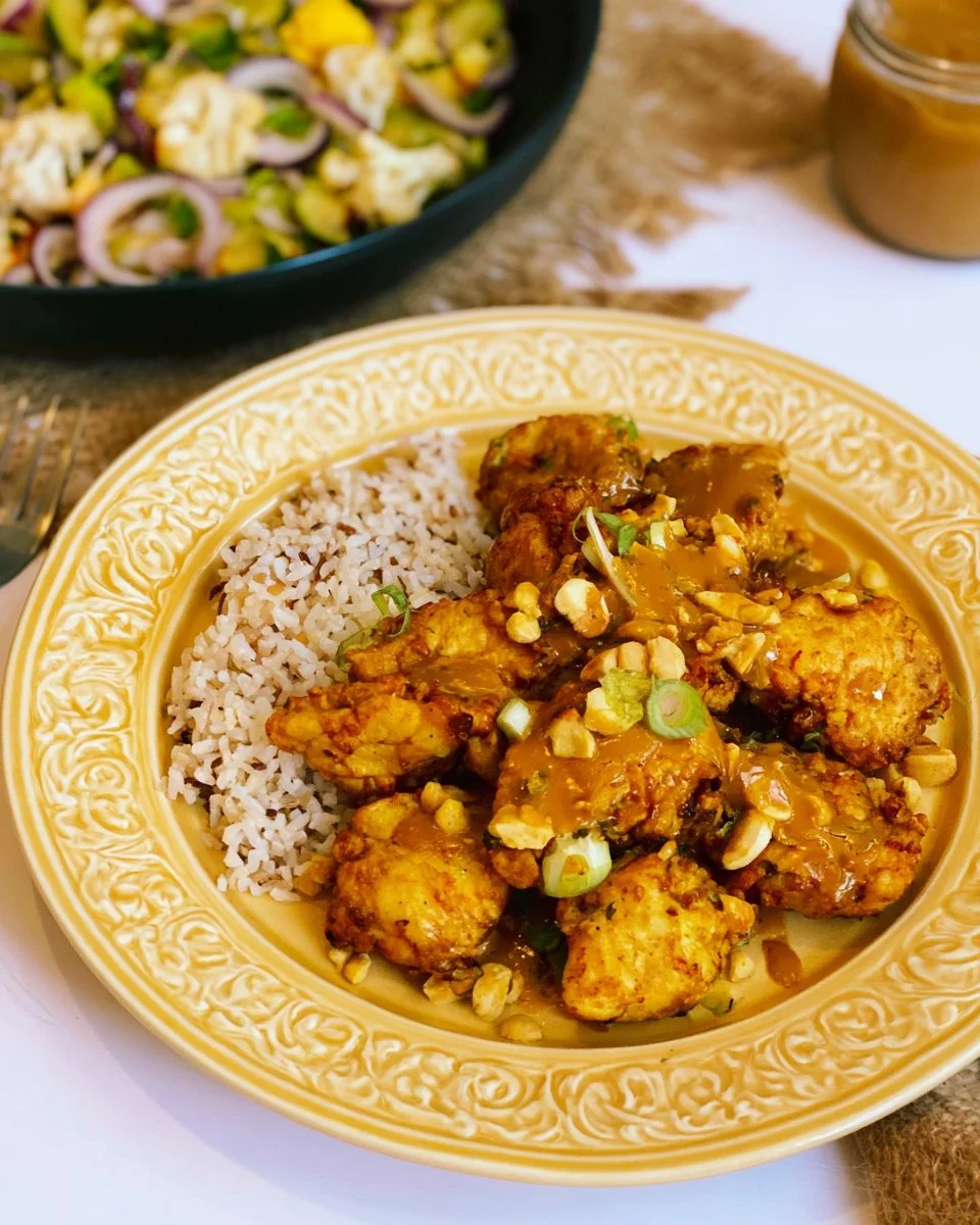 Air fried chicken served with flavorful peanut sauce on a plate.