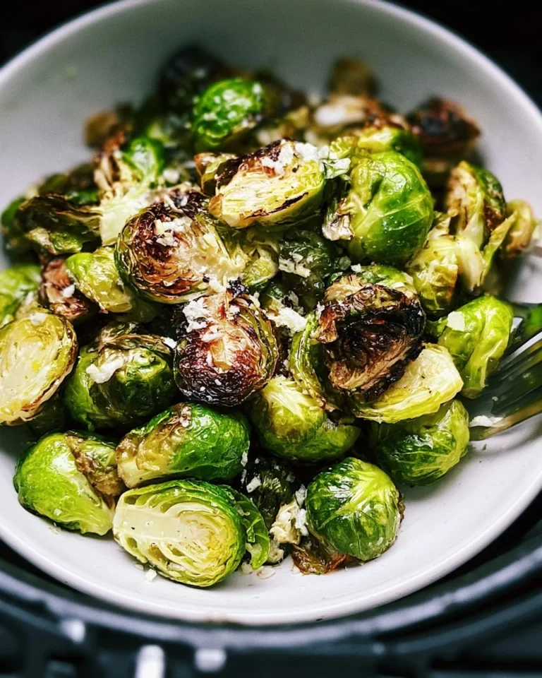 Crispy air fryer Brussels sprouts served in a bowl with seasoning.