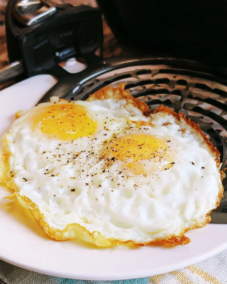 Air fryer fried eggs on a plate, ready to serve for breakfast